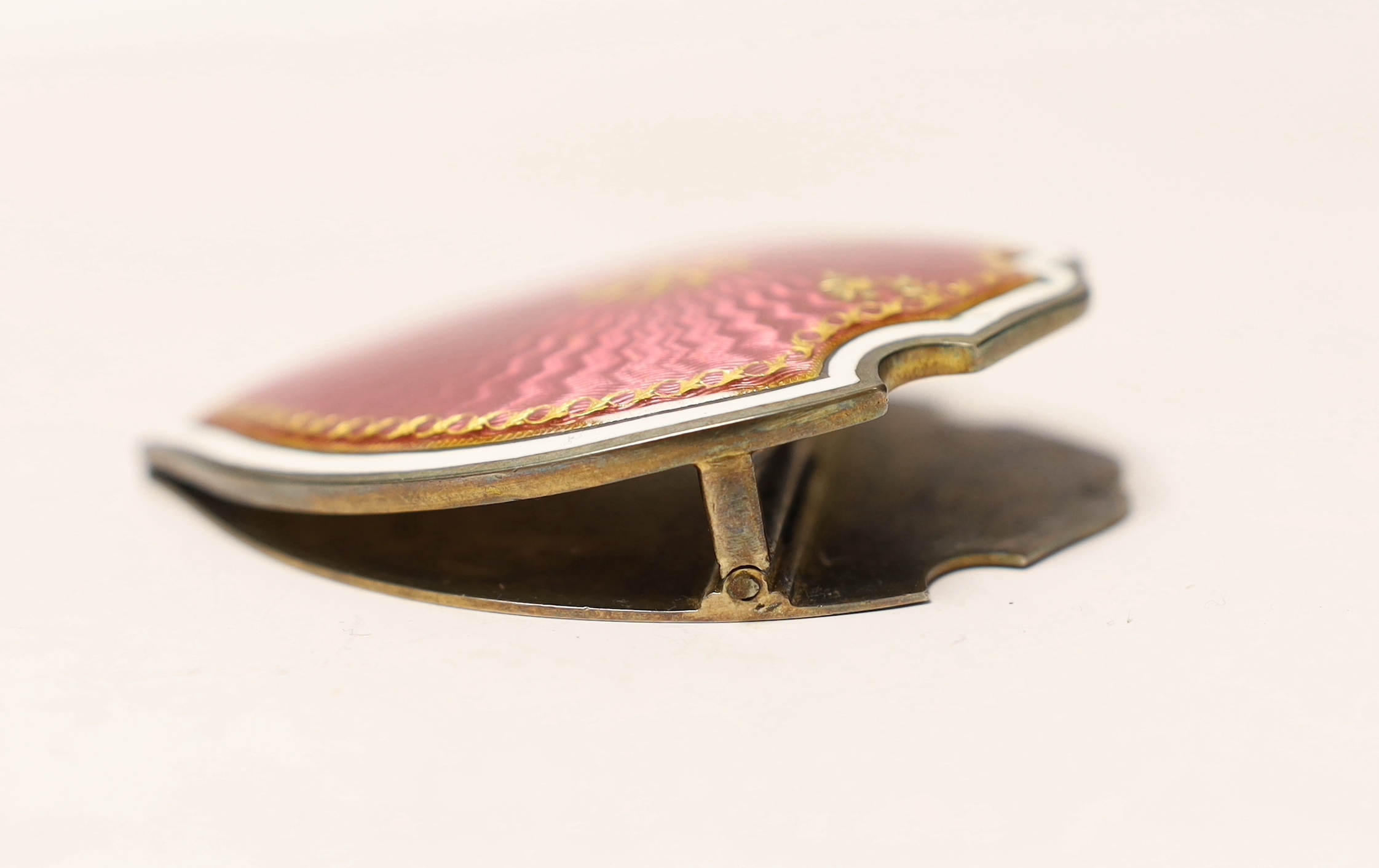 A French gilt white metal (boar's head mark) and enamelled shield shaped desk clip, inscribed 'E. Dreyfous to their Majesties', 78mm.